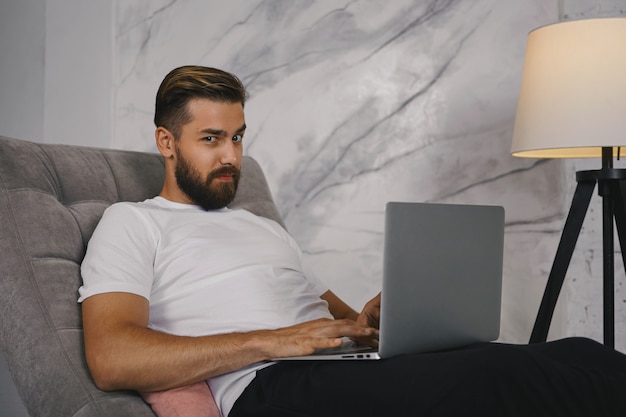 man using a laptop for video calling a psychic for online reading